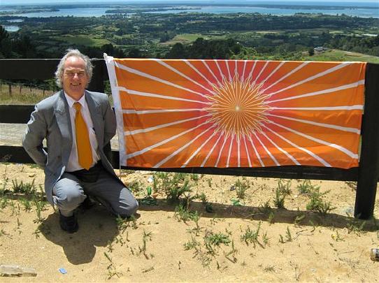 Stephen, flag and upper harbour background.JPG - Raising the flag of the Global Country of World Peace in honour of Maharishi's Second Year of Invincibility - Global Raam Raj, 12 January 2009, at potential site for the Peace Palace on North Island in New Zealand.